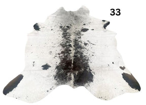 Speckled longhorn cowhide rug number 33 with natural markings and tonal variation on a white background