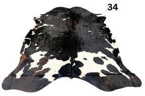 Tri colour cowhide rug number 34 with strong central contrast and natural markings on a white background