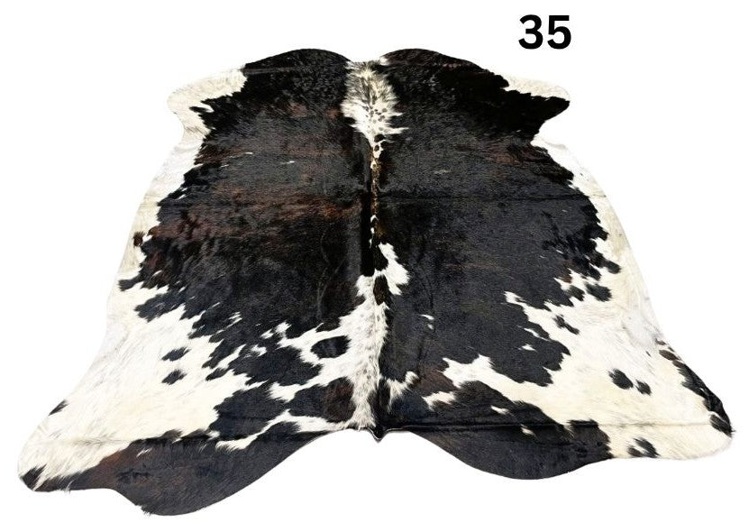Tri colour cowhide rug number 35 with strong central contrast and natural markings on a white background