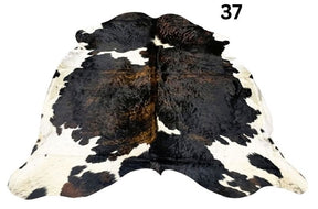 Tri colour cowhide rug number 37 with strong central contrast and natural markings on a white background