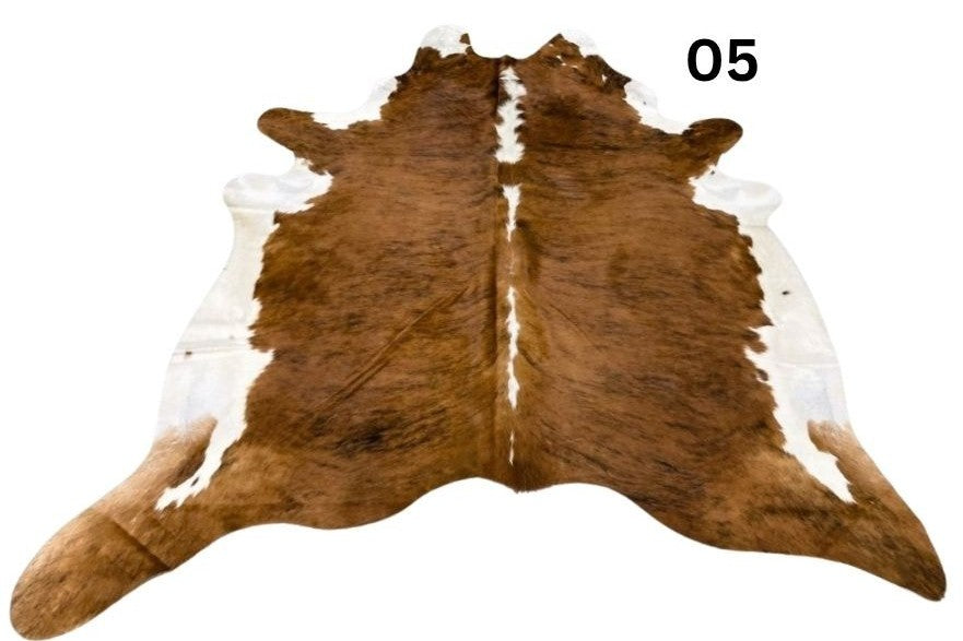 Cowhide rug number 05 with white belly and white spine featuring rich brindle tones and natural markings on a white background