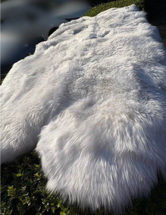 White merino sheepskin rug shown outdoors highlighting natural wool texture
