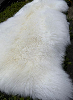 White Merino sheepskin rug shown in full natural hide shape
