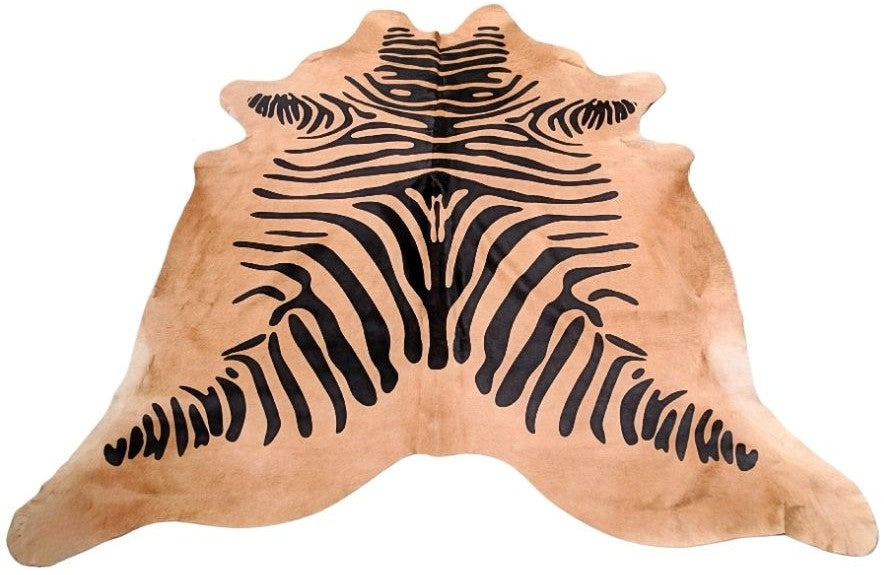 Zebra print cowhide rug in black pattern on natural beige hide displayed as a full rug