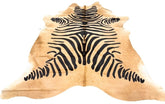 Zebra print cowhide rug in black on natural beige hide displayed as a full rug