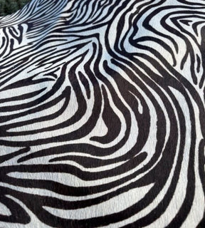 Close-up of zebra print cowhide side showing black and white pattern on natural hair-on-hide leather