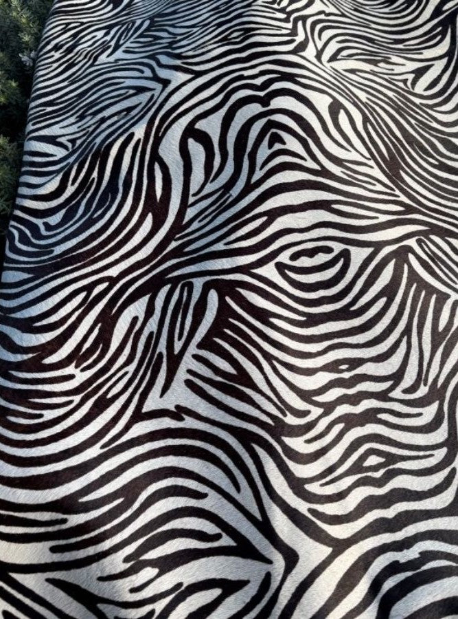 Zebra print cowhide side texture showing black and white pattern on natural hair-on-hide leather