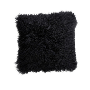 Black Mongolian sheepskin cushion with long hair texture photographed flat on a white background