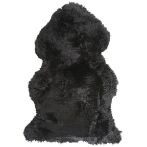 Black Merino sheepskin rug shown in full natural hide shape