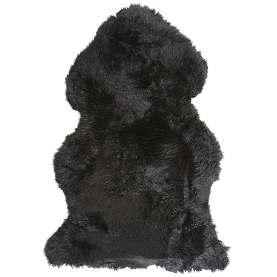 Black Merino sheepskin rug shown in full natural hide shape