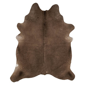 Example of a mocha latte cowhide rug with natural markings shown on a white background