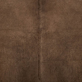 Close-up detail of mocha latte cowhide rug showing natural hair texture and markings