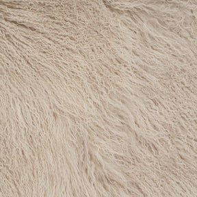 Close-up detail of fawn Mongolian sheepskin cushion showing long, soft hair texture