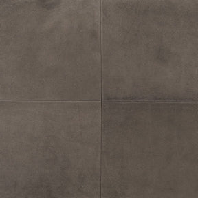 Close-up of grey nubuck leather cushion showing smooth matte texture and panel construction