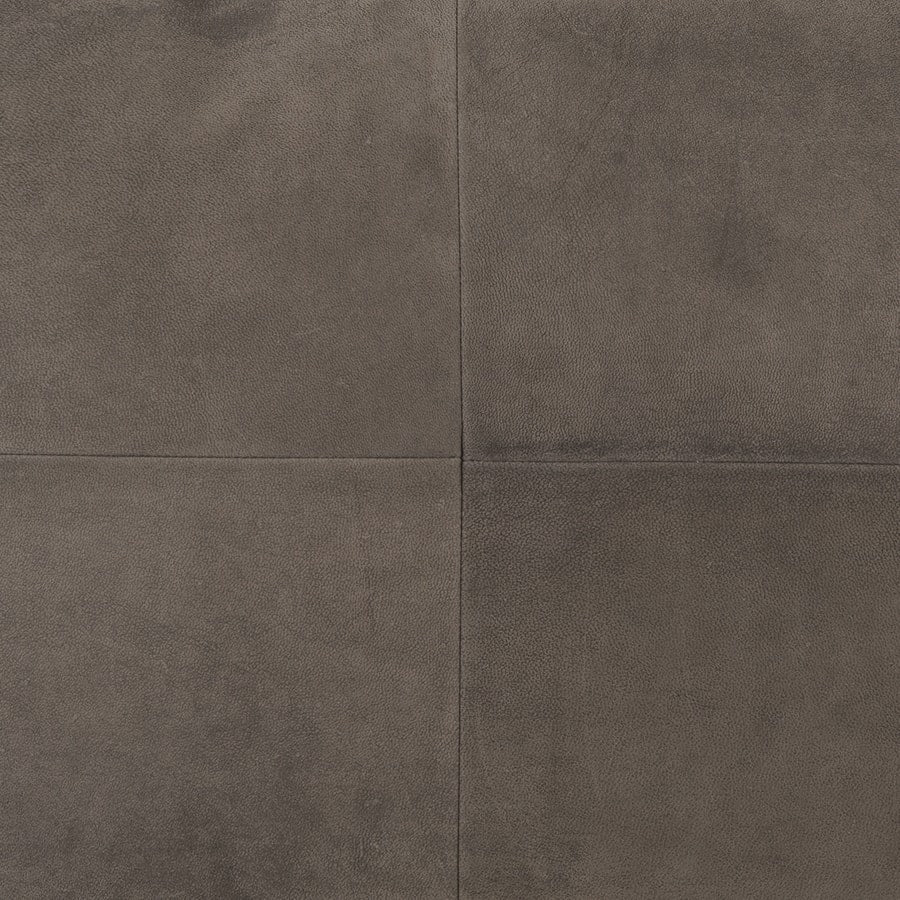 Close-up of grey nubuck leather cushion showing smooth matte texture and panel construction