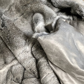 Grey rabbit hide blanket showing velour cotton backing and natural hair edge