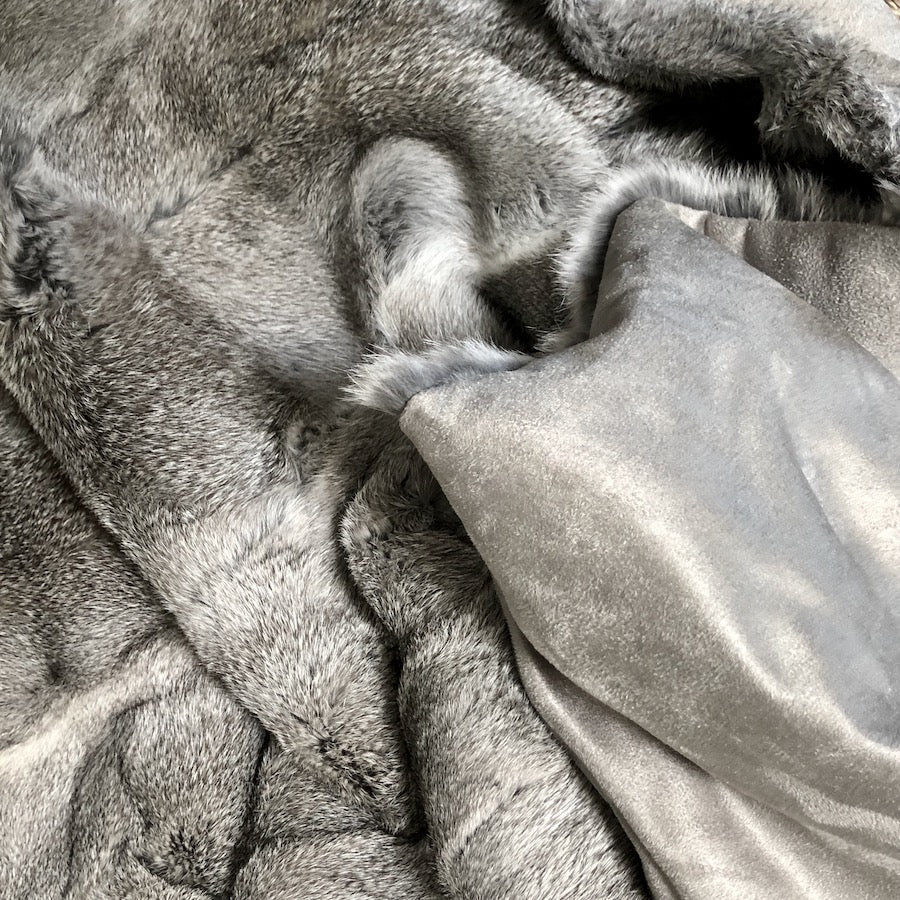 Grey rabbit hide blanket showing velour cotton backing and natural hair edge