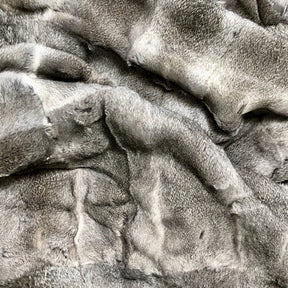 Close-up of grey rabbit hide blanket showing individual natural hair panels