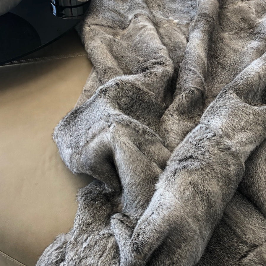 Close-up of grey rabbit hide blanket showing natural soft hair texture