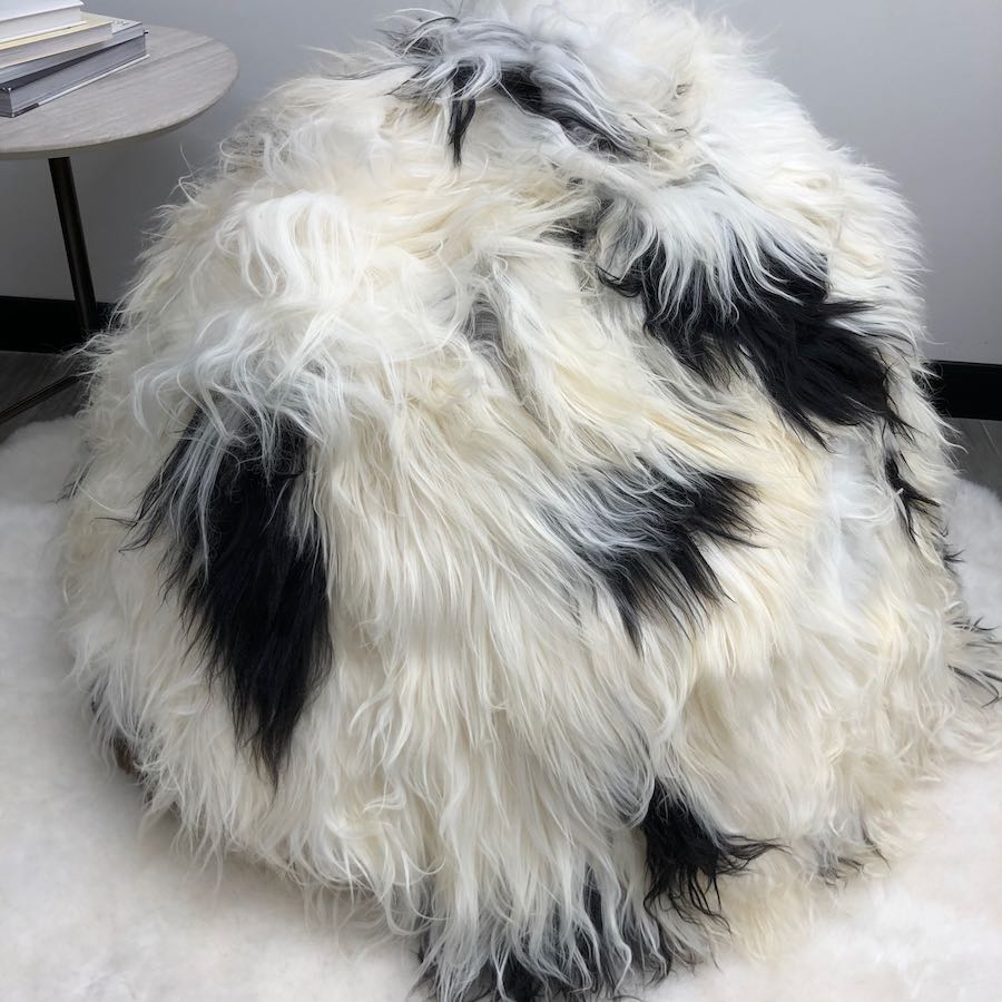 Close-up view of an Icelandic sheepskin bean bag in natural black and white spot showing long wool texture