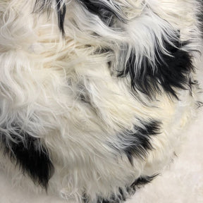 Close-up detail of long wool Icelandic sheepskin showing natural black and white spotted texture