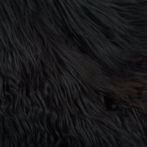Close-up detail of brown and black Icelandic sheepskin showing long, natural wool texture