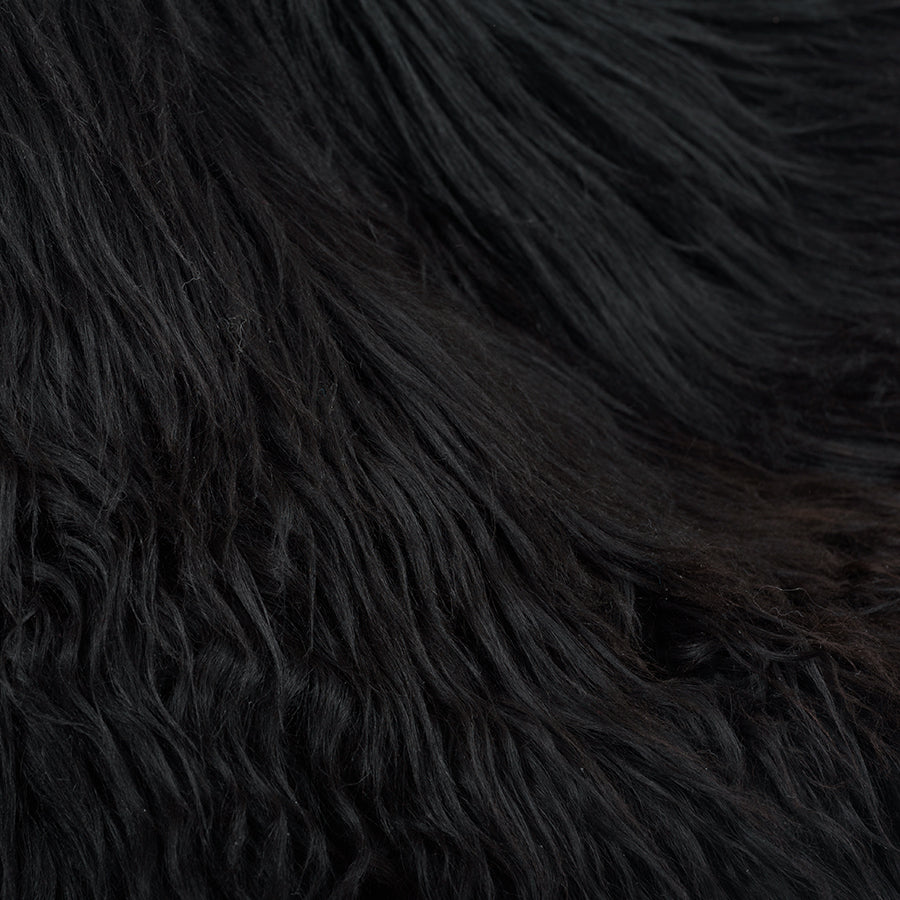 Close-up detail of brown and black Icelandic sheepskin showing long, natural wool texture