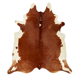 Large brown and white Hereford cowhide rug with natural symmetrical markings on a white background
