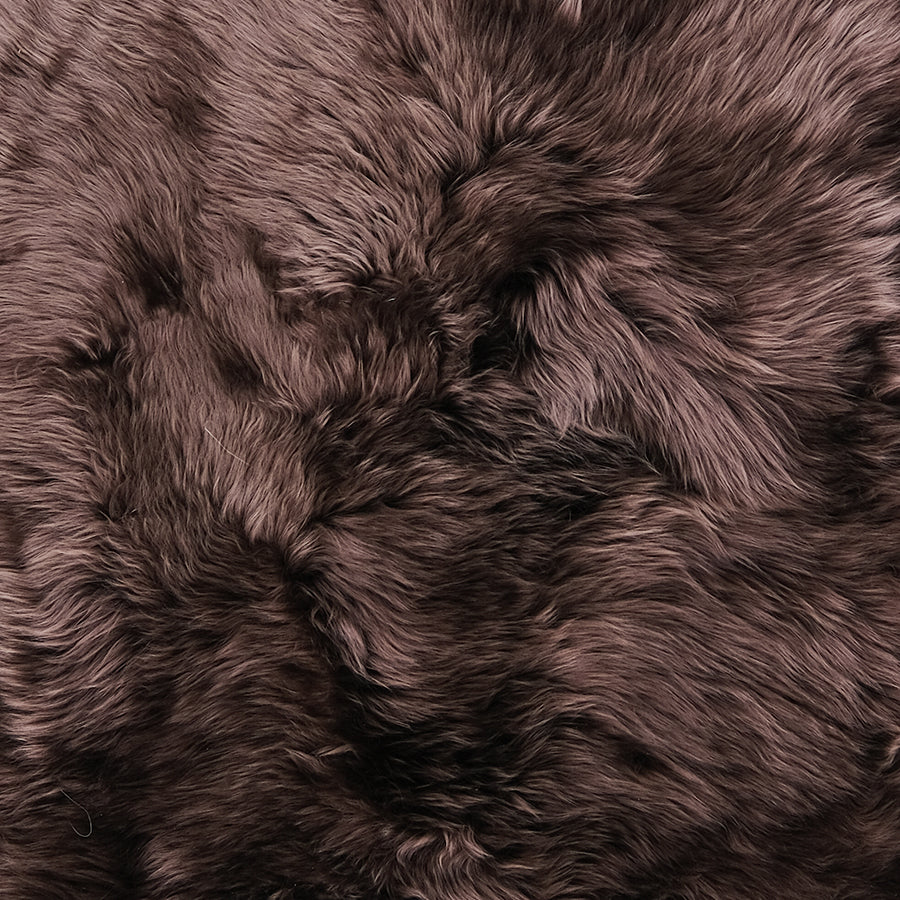 Close up of merino sheepskin rug in a rich chocolate tone showing soft dense wool texture-1