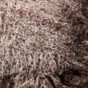 Close-up detail of camel Mongolian sheepskin showing soft, silky long wool texture