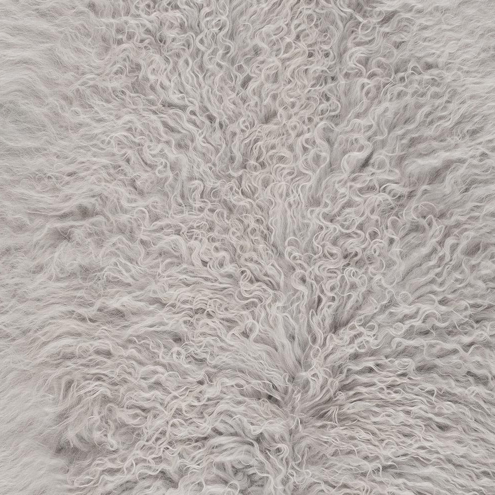 Close-up detail of light grey Mongolian sheepskin showing soft, silky long wool