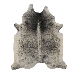Natural salt and pepper cowhide rug with unique speckled markings photographed flat on a white background