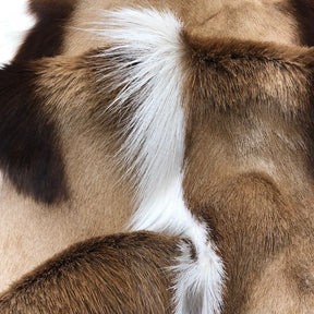 Close‑up detail of a genuine Springbok hide rug showing natural tan and white hair‑on‑hide texture and unique markings