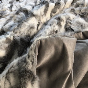 White and grey rabbit hide blanket showing cotton velour backing and natural hair edge