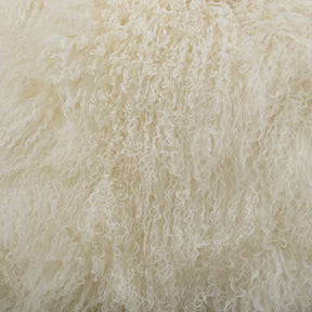Close-up detail of white Mongolian sheepskin cushion showing long, soft hair texture
